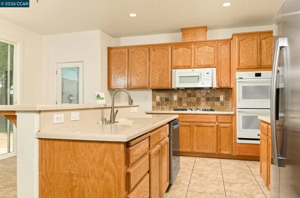 a kitchen with stainless steel appliances granite countertop a sink and a cabinets