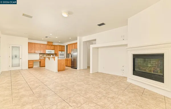 a kitchen with granite countertop a refrigerator and a sink