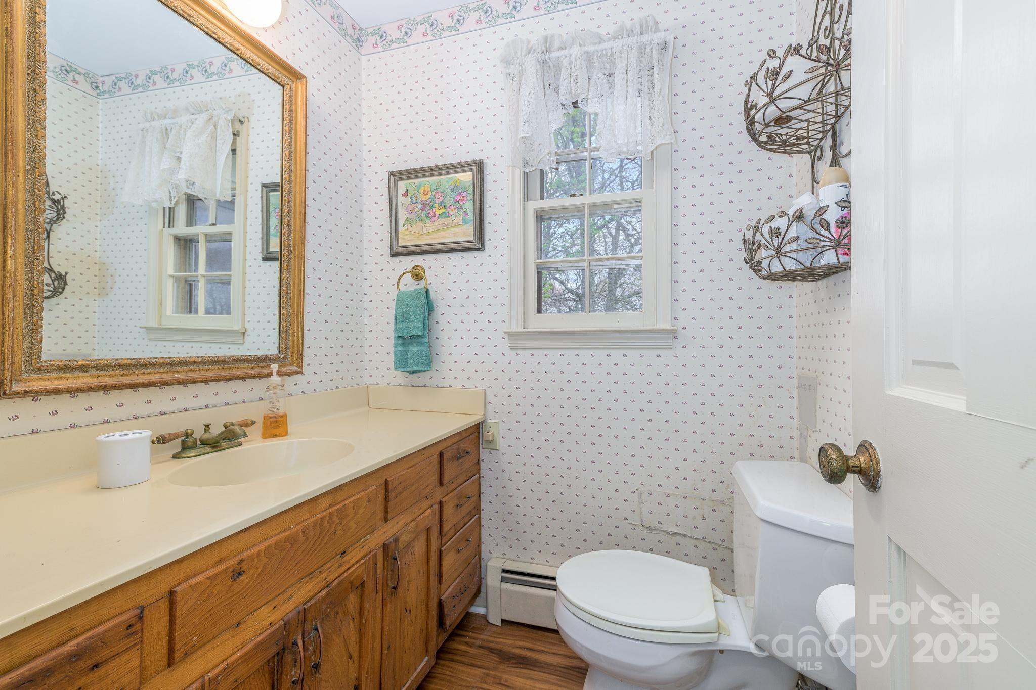 184 Buff Ridge Road Boone, NC 28607 - Photo 12 of 42 a bathroom with a sink a toilet and a window