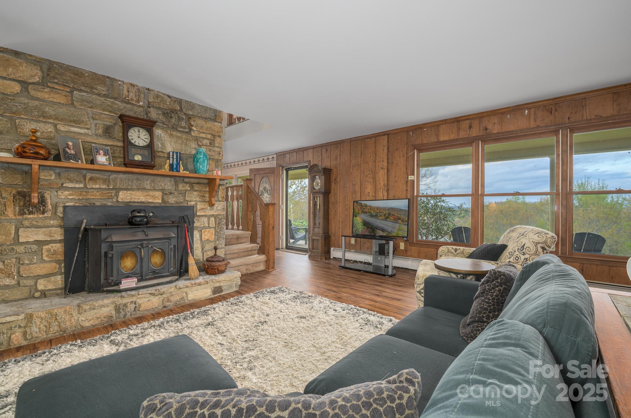 184 Buff Ridge Road Boone, NC 28607 - Photo 13 of 42 a living room with furniture a large window and a fireplace