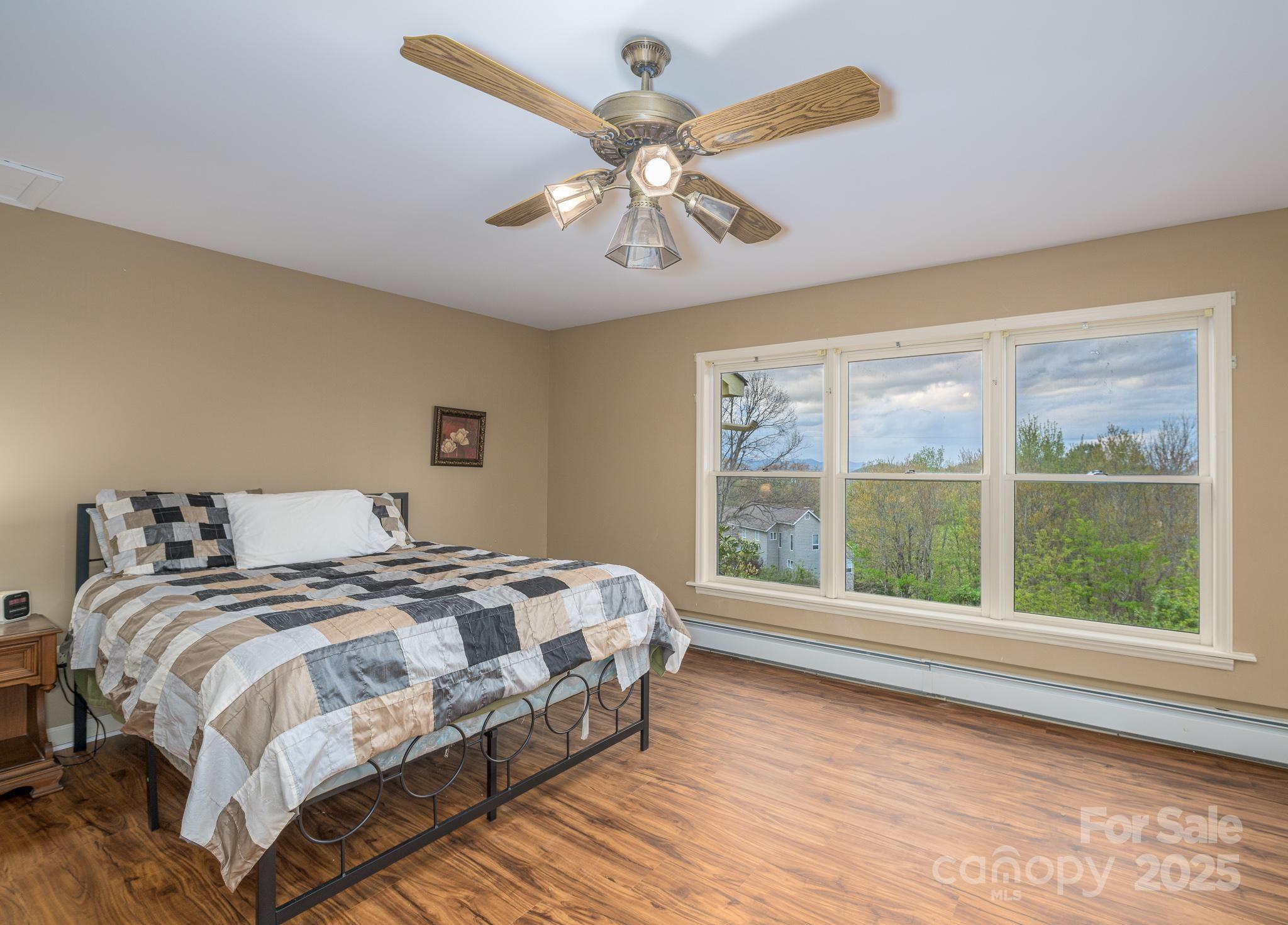 184 Buff Ridge Road Boone, NC 28607 - Photo 15 of 42 a bedroom with a large bed and a large window