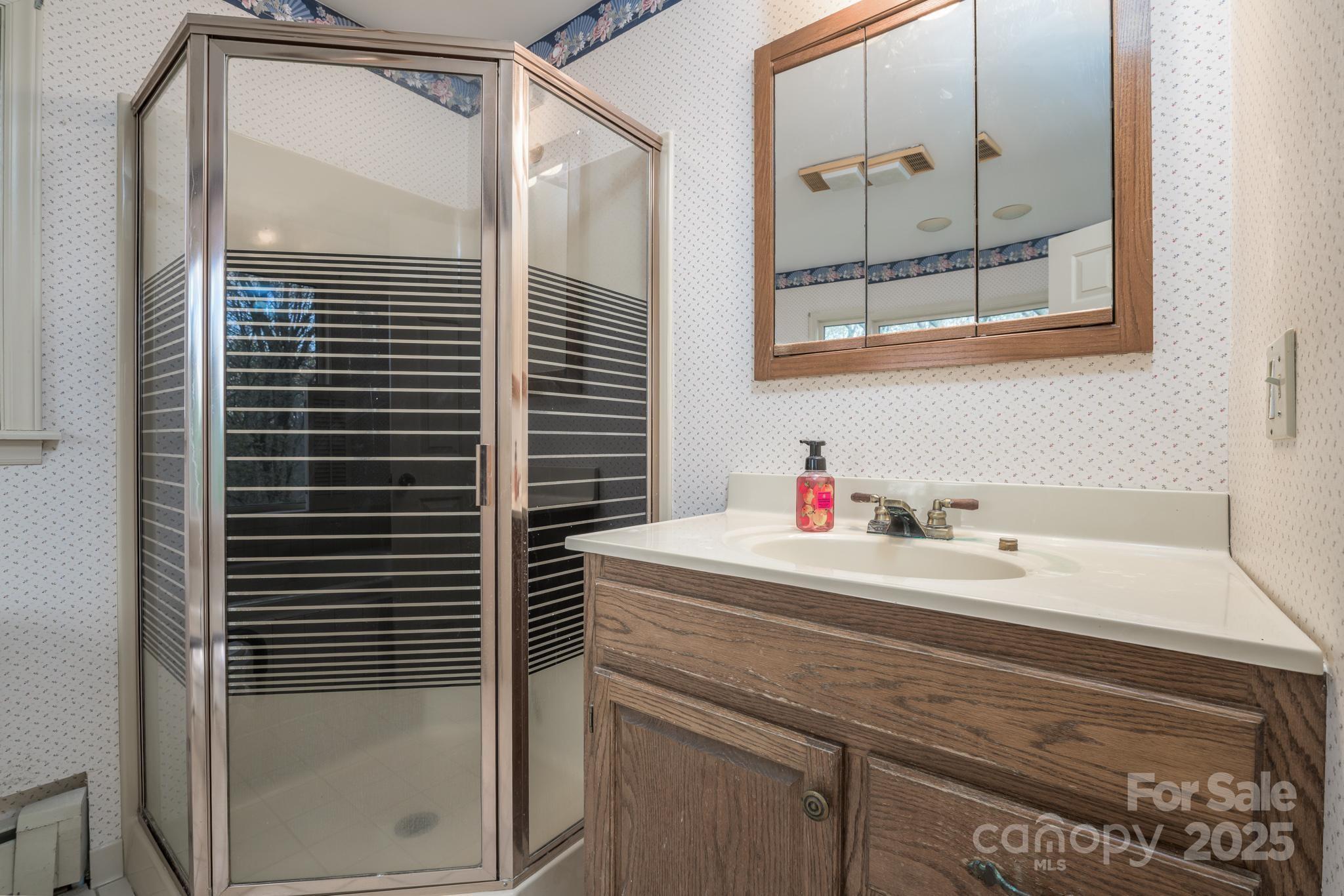 184 Buff Ridge Road Boone, NC 28607 - Photo 18 of 42 a bathroom with a sink and a mirror
