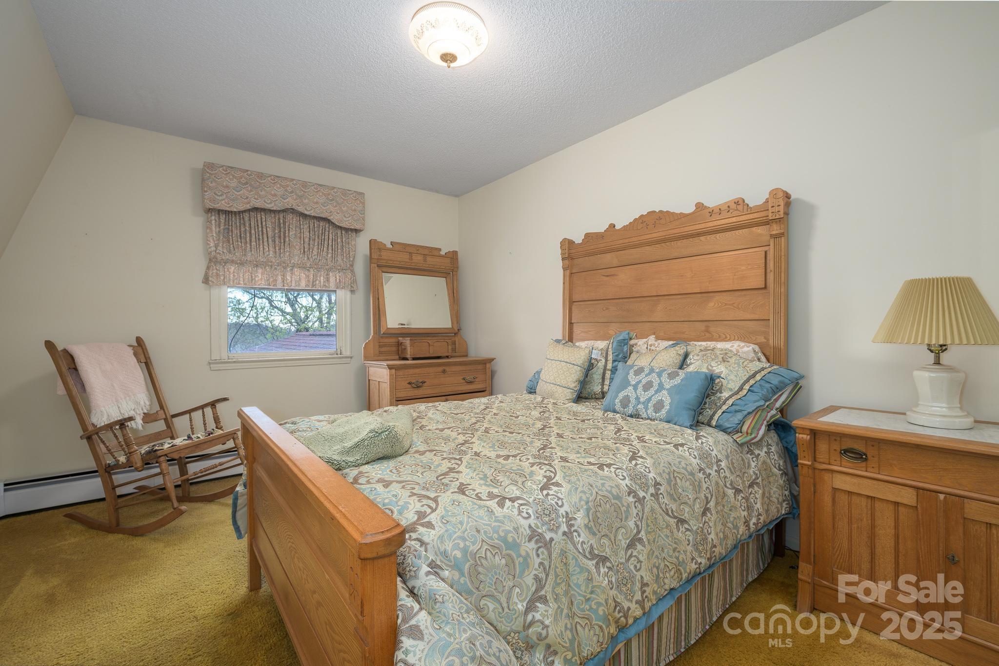 184 Buff Ridge Road Boone, NC 28607 - Photo 21 of 42 a bedroom with a bed and window