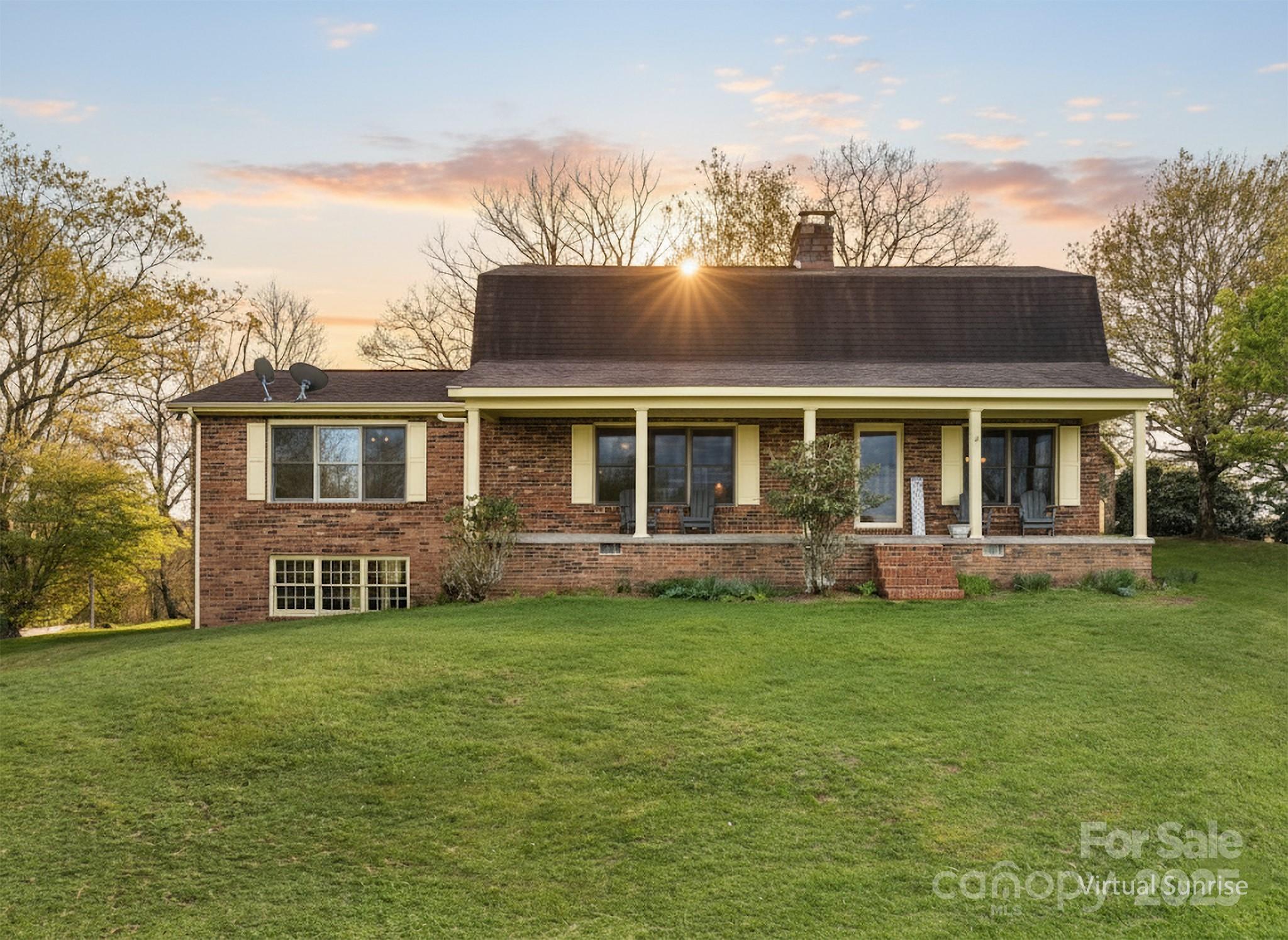 184 Buff Ridge Road Boone, NC 28607 - Photo 28 of 42 a front view of a house with a garden