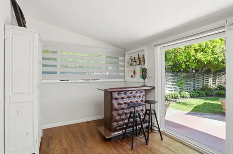 a dining room with furniture window and wooden floor