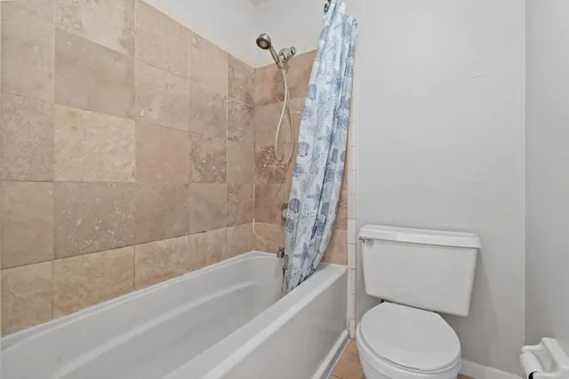 a bathroom with a toilet and a bathtub