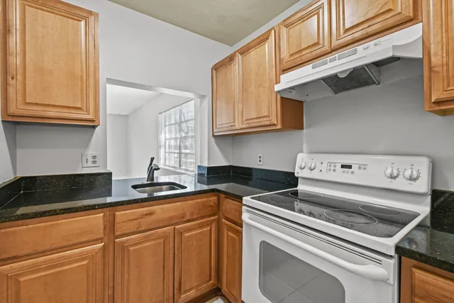 a kitchen with a stove and a sink