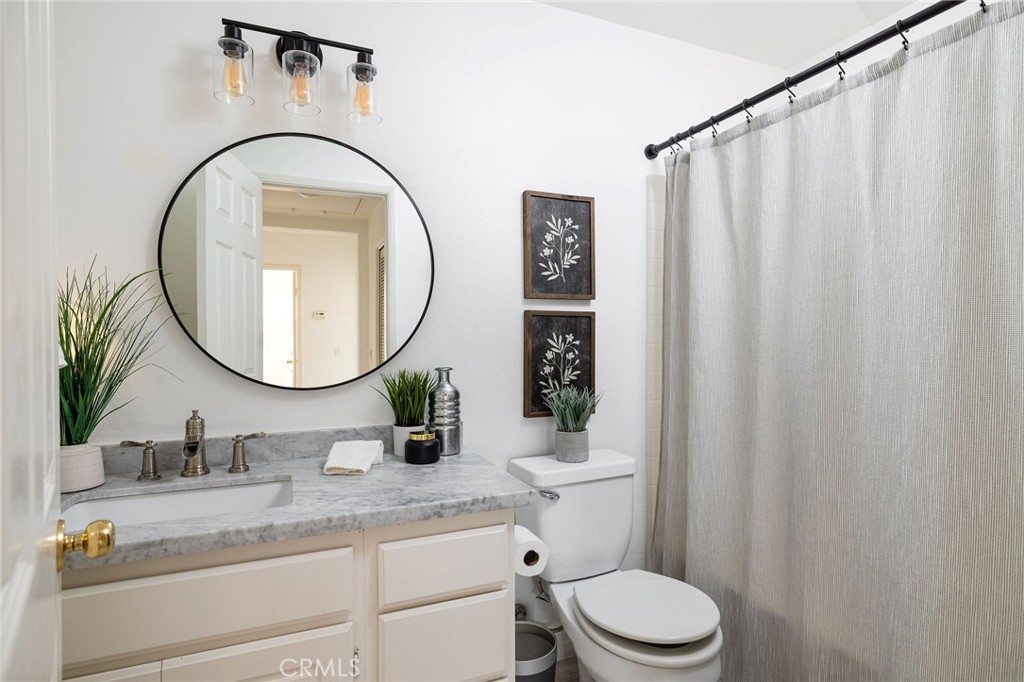 34 Bayley Street Ladera Ranch, CA 92694 - Photo 15 of 24 a bathroom with a granite countertop sink mirror a toilet and a sink