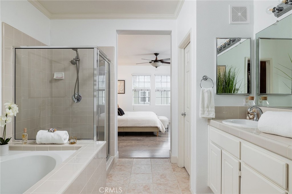 34 Bayley Street Ladera Ranch, CA 92694 - Photo 19 of 24 a en suite bathroom with a granite countertop tub sink a shower and a mirror