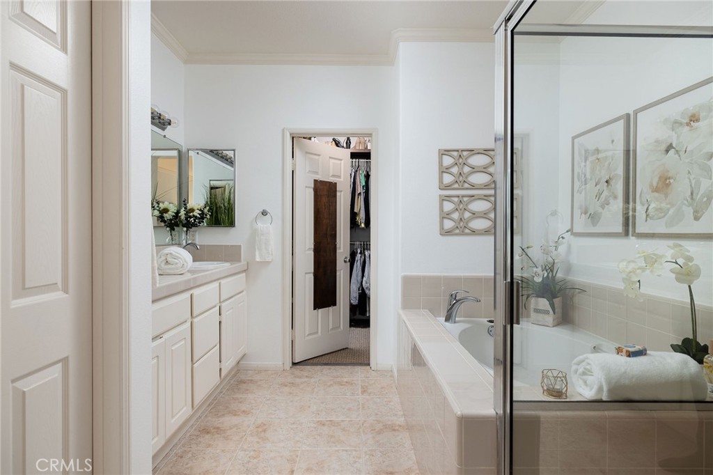 34 Bayley Street Ladera Ranch, CA 92694 - Photo 21 of 24 a bathroom with a tub sink and mirror