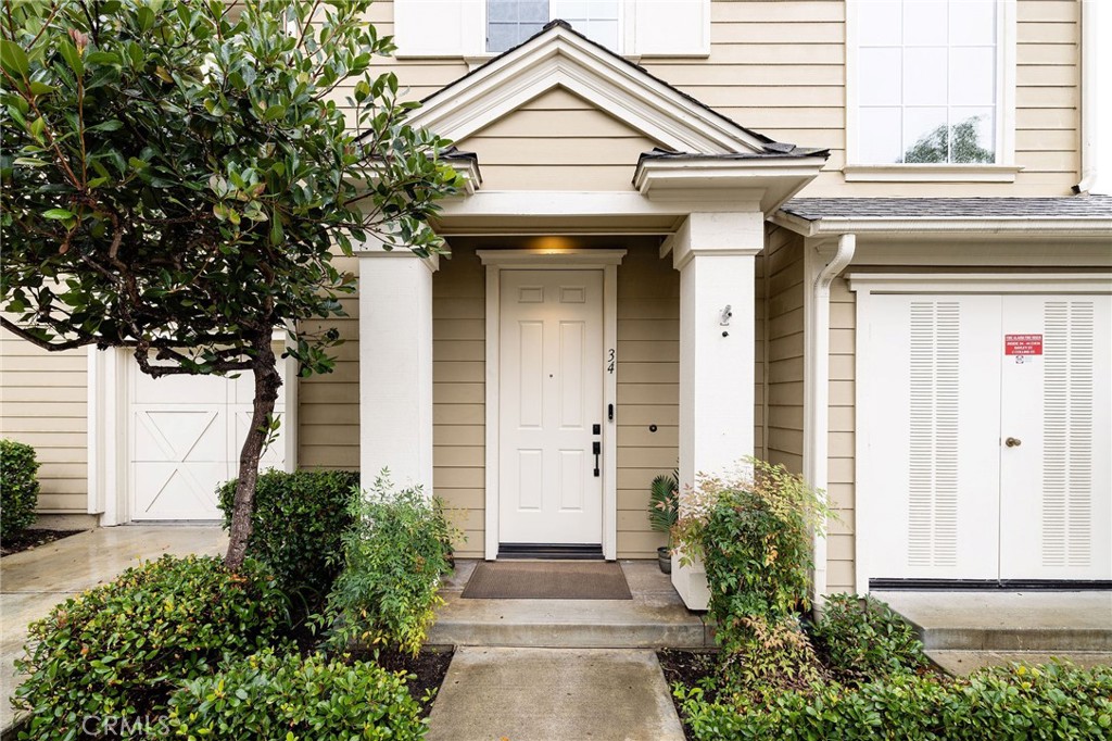 34 Bayley Street Ladera Ranch, CA 92694 - Photo 3 of 24 a front view of a house with a yard and garage
