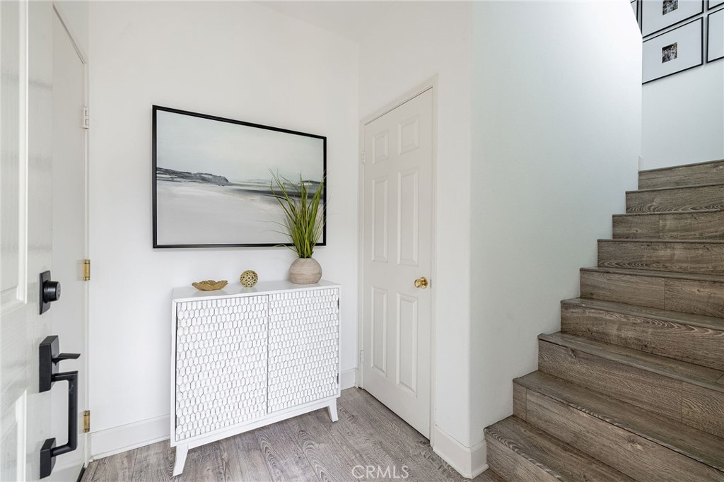 34 Bayley Street Ladera Ranch, CA 92694 - Photo 4 of 24 a view of a hallway with wooden floor and entryway