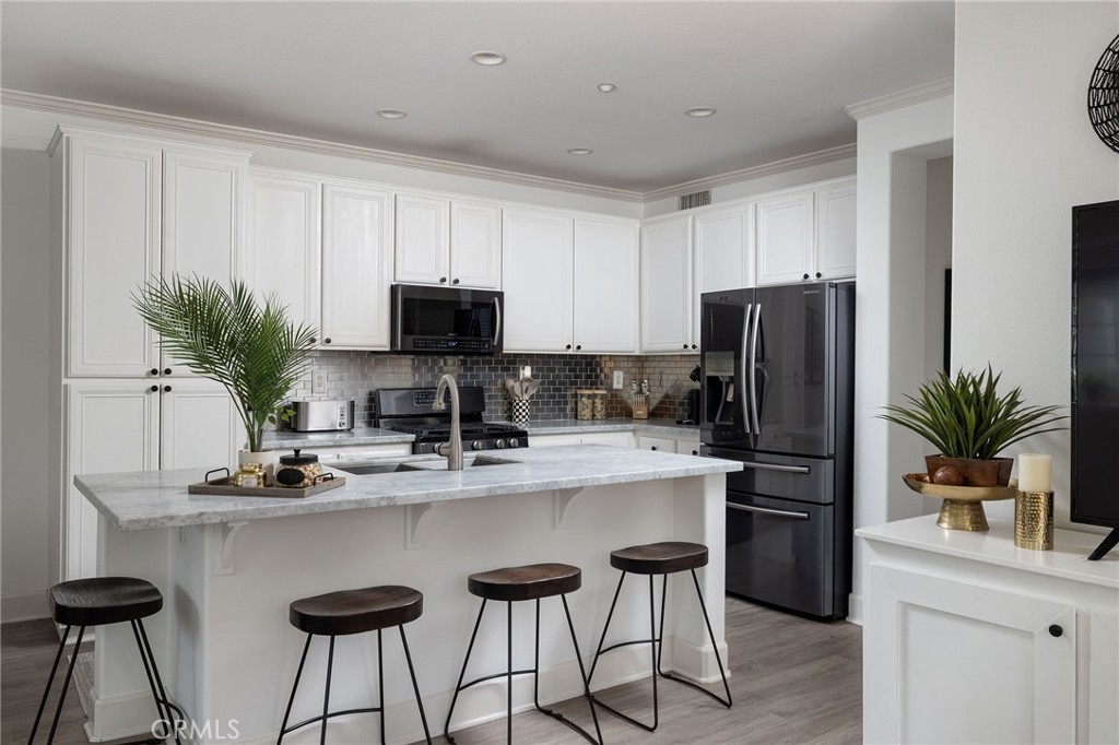 34 Bayley Street Ladera Ranch, CA 92694 - Photo 7 of 24 a kitchen with appliances a counter space and a refrigerator