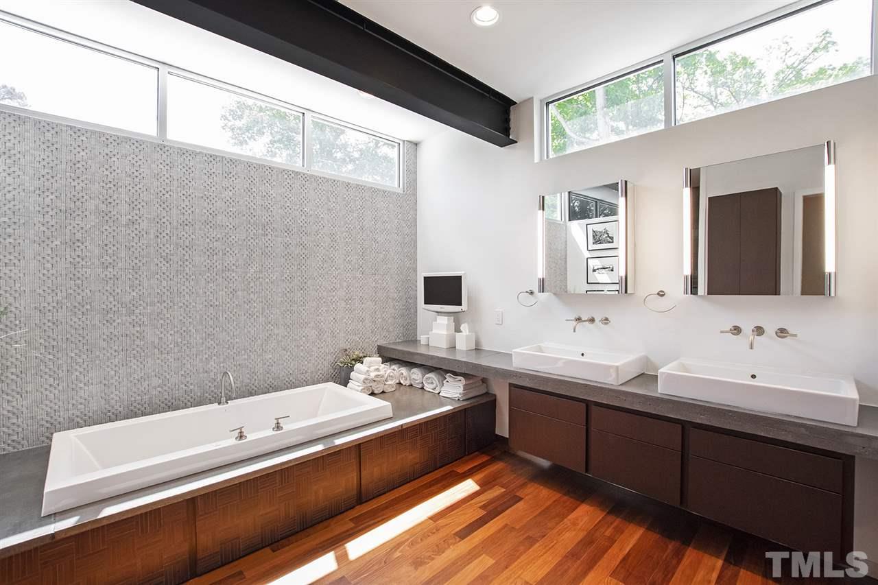 1825 Stillwater Drive Raleigh, NC 27607 - Photo 11 of 22 a spacious bathroom with a double vanity sink and mirror