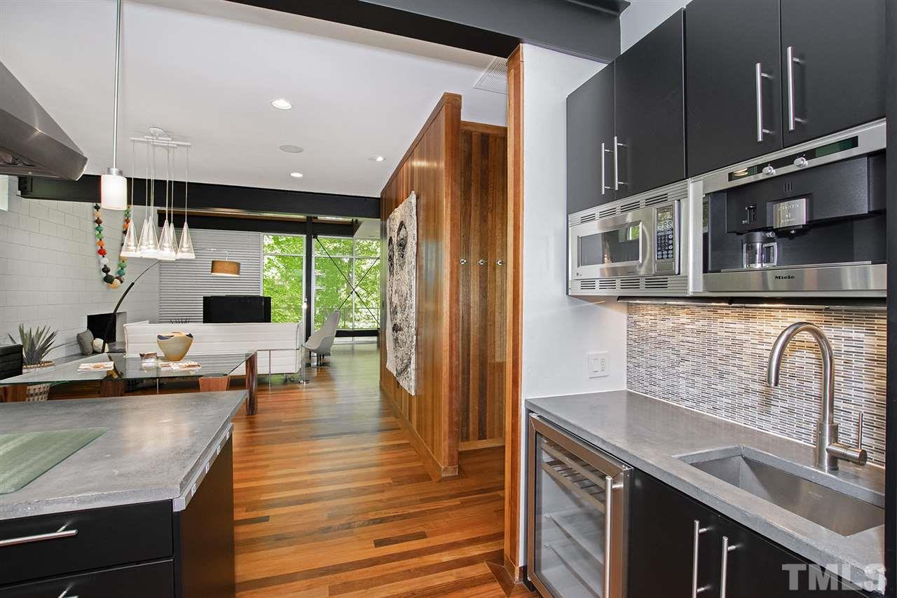 1825 Stillwater Drive Raleigh, NC 27607 - Photo 14 of 22 a kitchen with stainless steel appliances granite countertop a sink a stove and a wooden cabinets