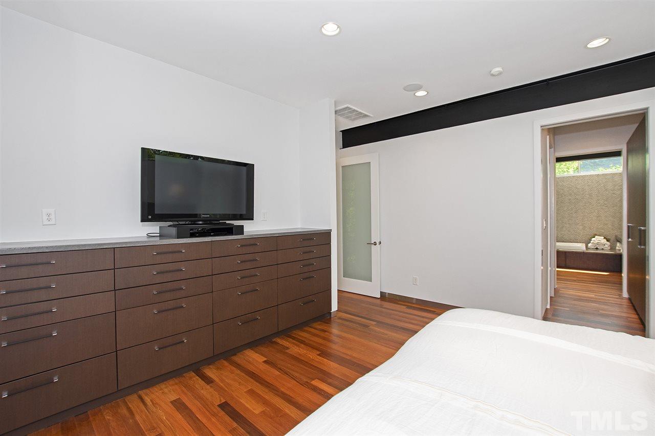 1825 Stillwater Drive Raleigh, NC 27607 - Photo 9 of 22 a room with a bed and a flat screen tv