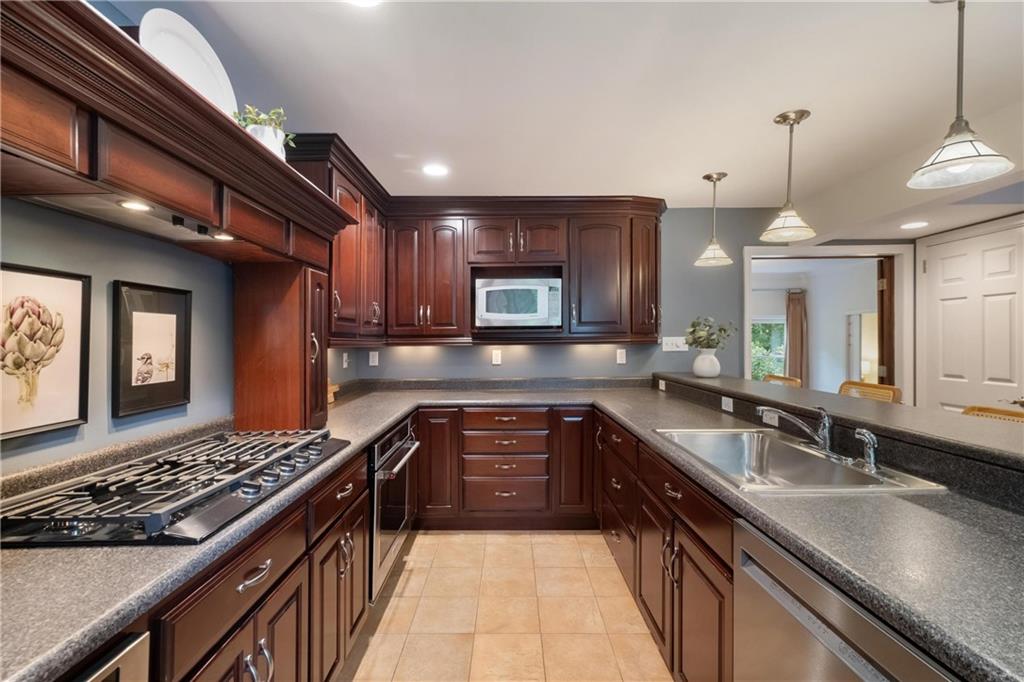 9550 Harding Road Pittsburgh, PA 15237 - Photo 15 of 44 a large kitchen with stainless steel appliances granite countertop a sink stove and cabinets