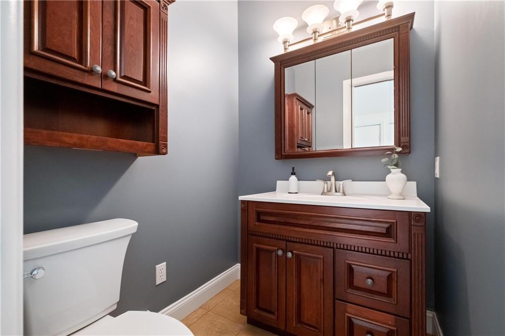 9550 Harding Road Pittsburgh, PA 15237 - Photo 18 of 44 a bathroom with a sink a toilet and mirror