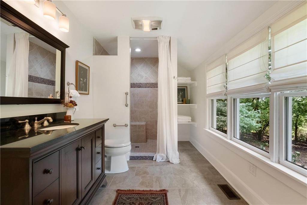 9550 Harding Road Pittsburgh, PA 15237 - Photo 23 of 44 a bathroom with a sink a toilet a large mirror and shower