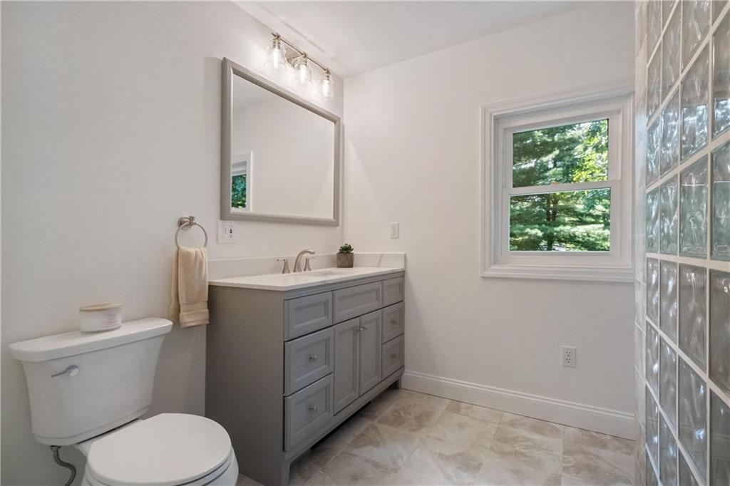 9550 Harding Road Pittsburgh, PA 15237 - Photo 26 of 44 a bathroom with a toilet a sink a vanity a window and mirror