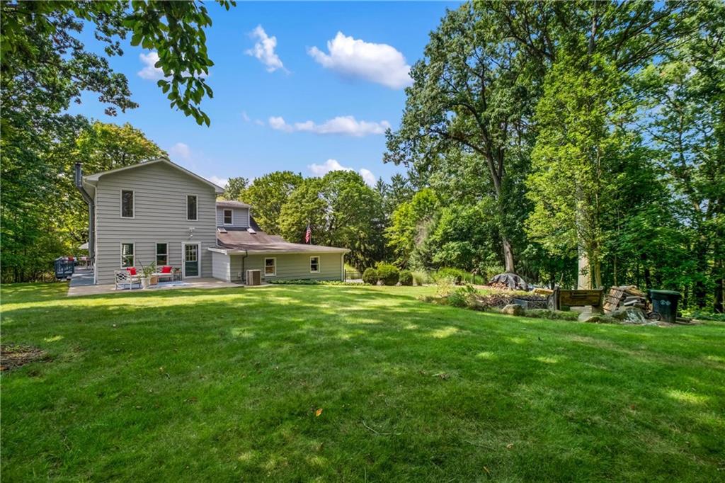 9550 Harding Road Pittsburgh, PA 15237 - Photo 39 of 44 a front view of a house with a yard and trees
