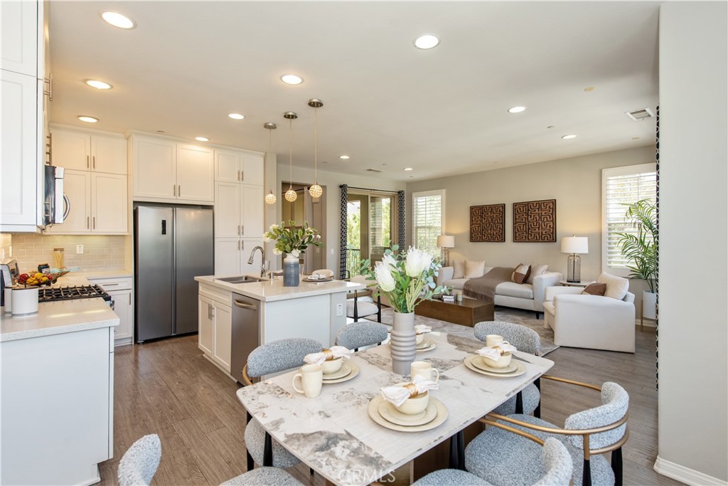 68 Origin Irvine, CA 92618 - Photo 12 of 43 a open dining room with stainless steel appliances furniture a large window and kitchen view