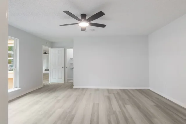 a bathroom with a granite countertop sink a toilet and a mirror