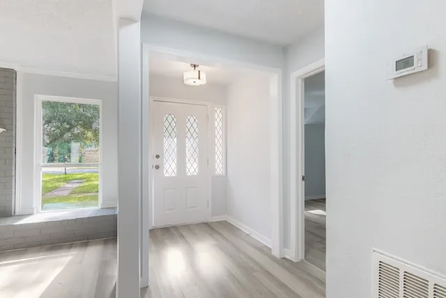 a view of an empty room with fire place and a fireplace