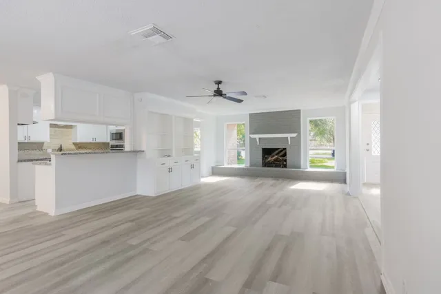 a view of a kitchen with a sink and a refrigerator