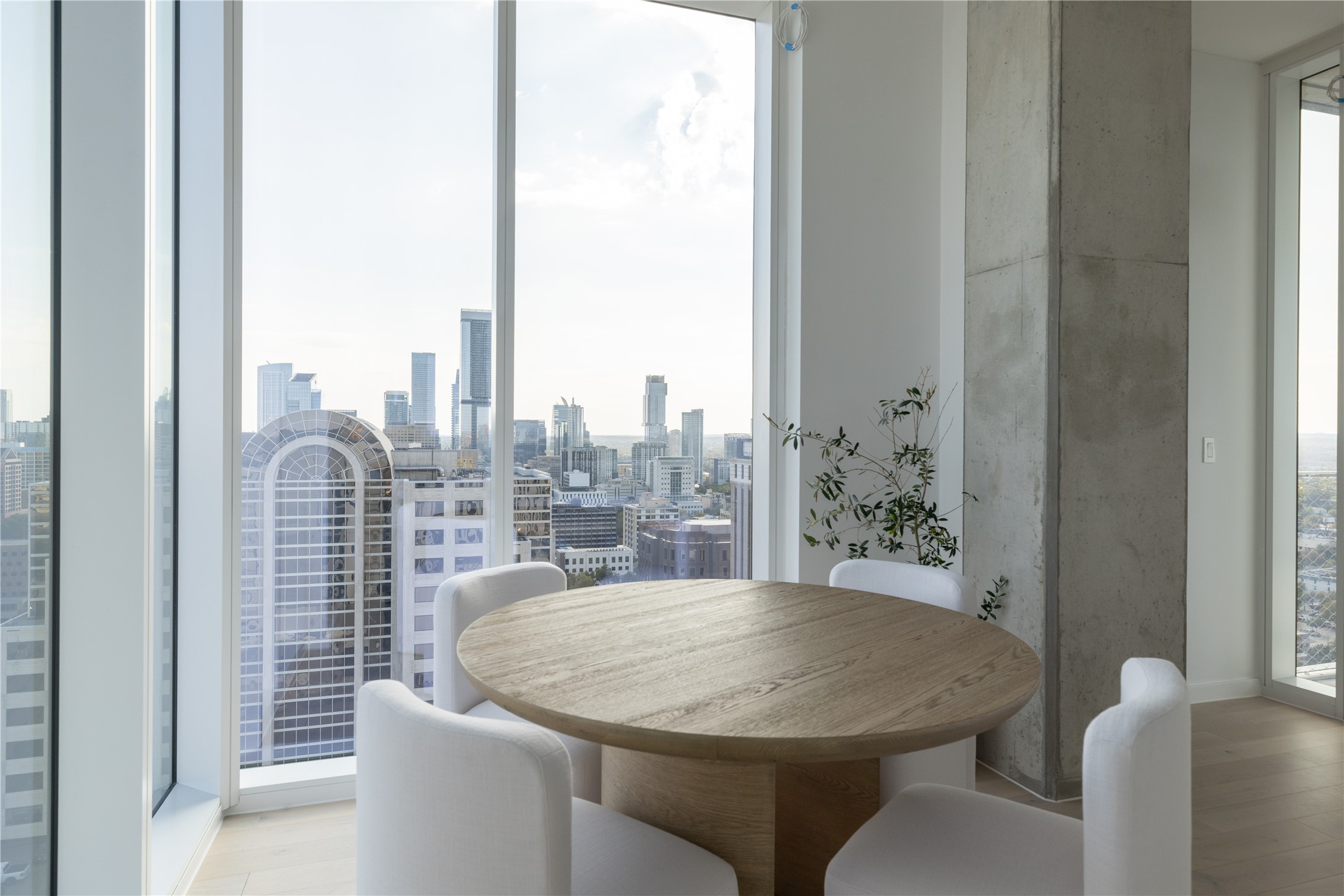 313 West 17th Street, Unit 2007 Austin, TX 78701 - Photo 12 of 38 Dining space with expansive windows, light wood-style flooring, and a skyline view
