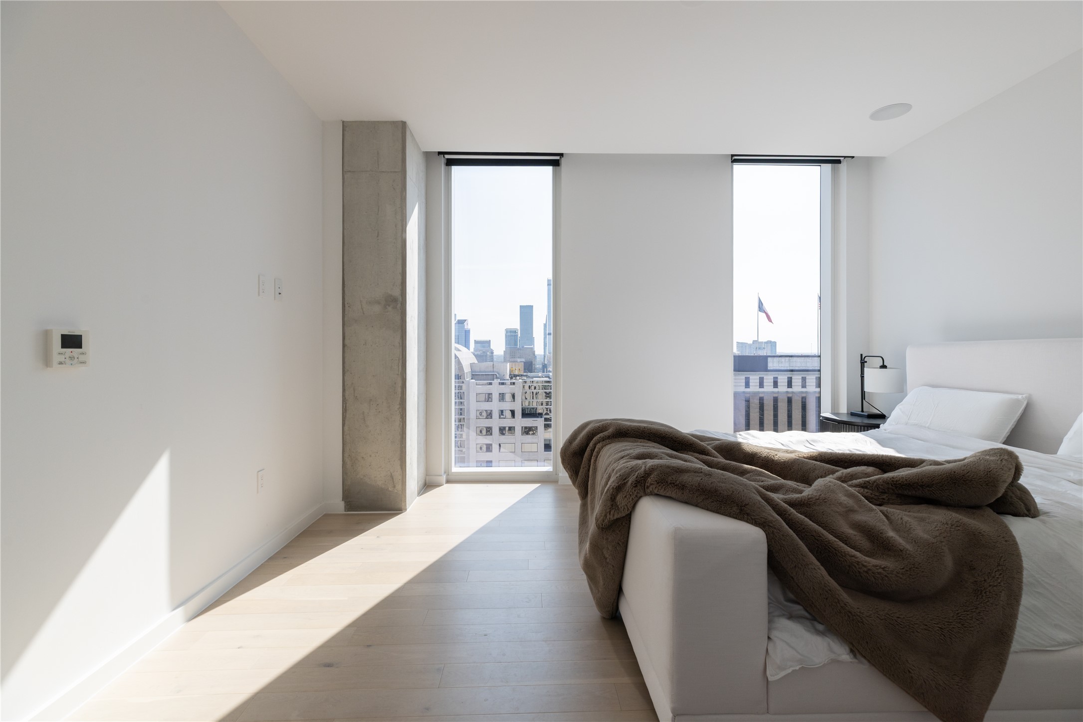 313 West 17th Street, Unit 2007 Austin, TX 78701 - Photo 18 of 38 Bedroom featuring wood finished floors and expansive windows