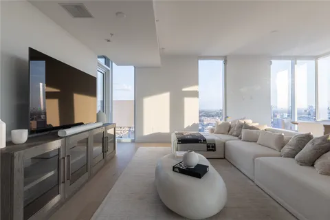 a large living room with furniture and a large window