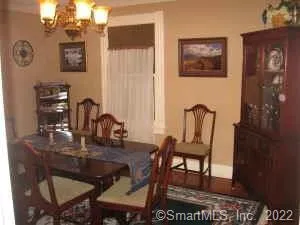 a view of a small space with a door and wooden floor