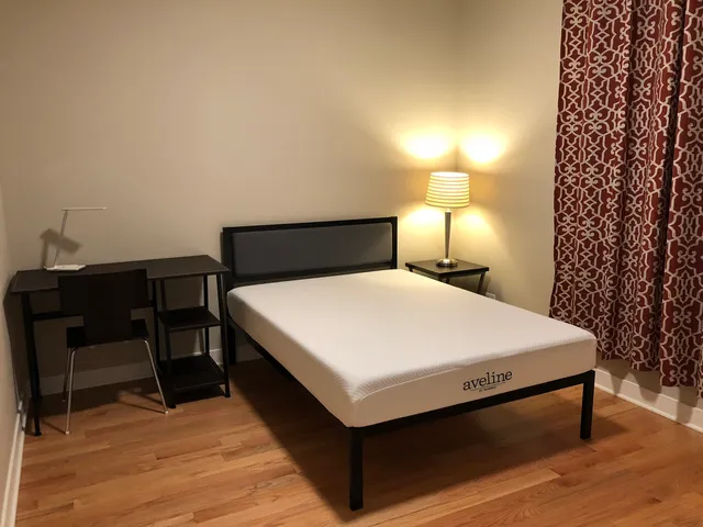 a bedroom with a bed and a table