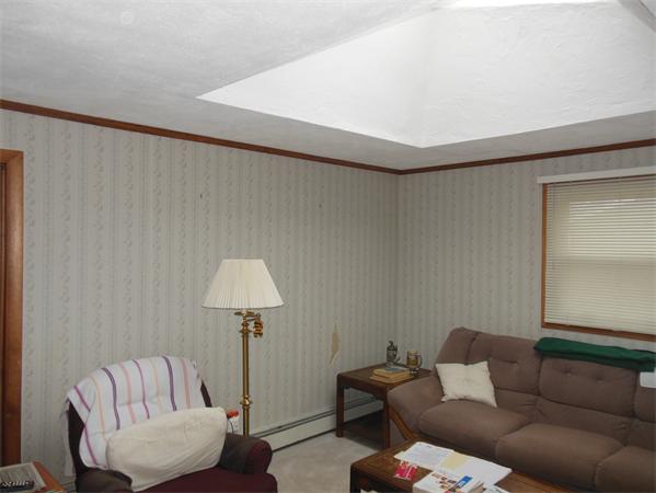 7 Dondi Road Beverly, MA 01915 - Photo 16 of 22 a living room with furniture and a lamp
