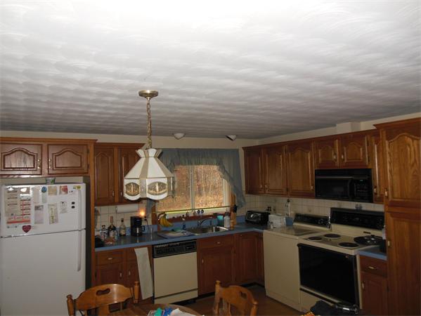 7 Dondi Road Beverly, MA 01915 - Photo 4 of 22 a kitchen with stainless steel appliances granite countertop a stove top oven a sink dishwasher and cabinets with wooden floor