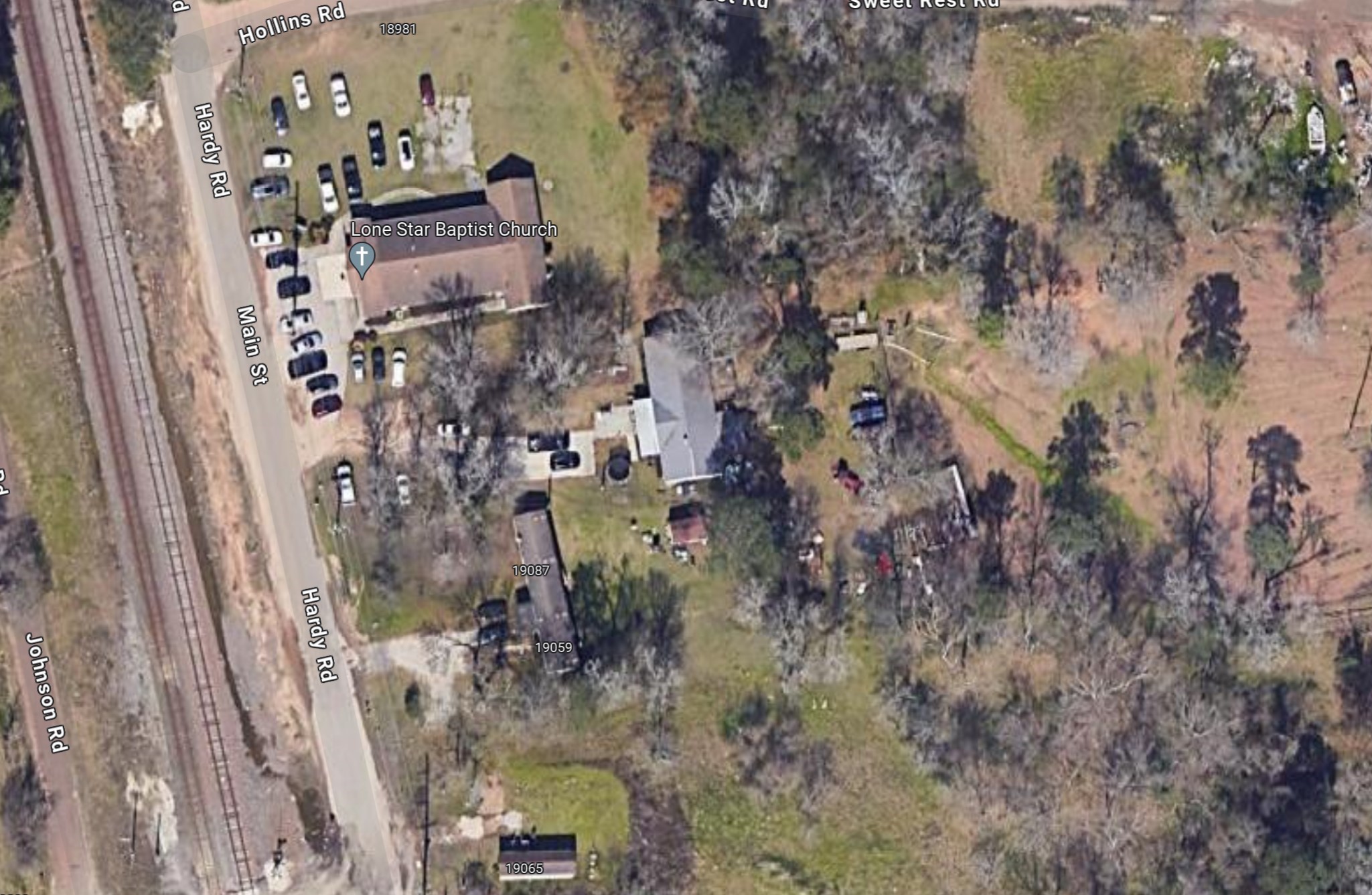 19059 Main Street Conroe, TX 77385 - Photo 2 of 7 a aerial view of a house with a yard
