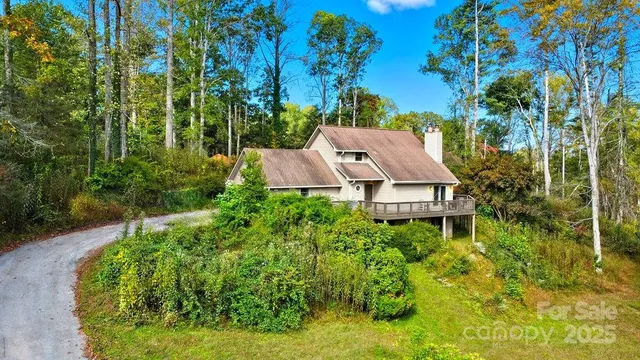 an aerial view of a house with swimming pool and garden