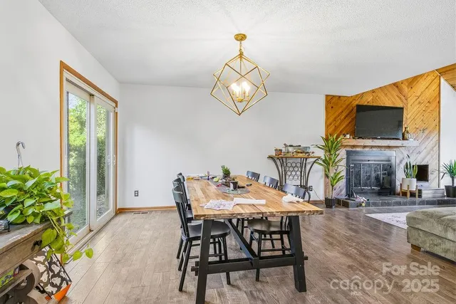 a view of a dining room with furniture and a chandelier
