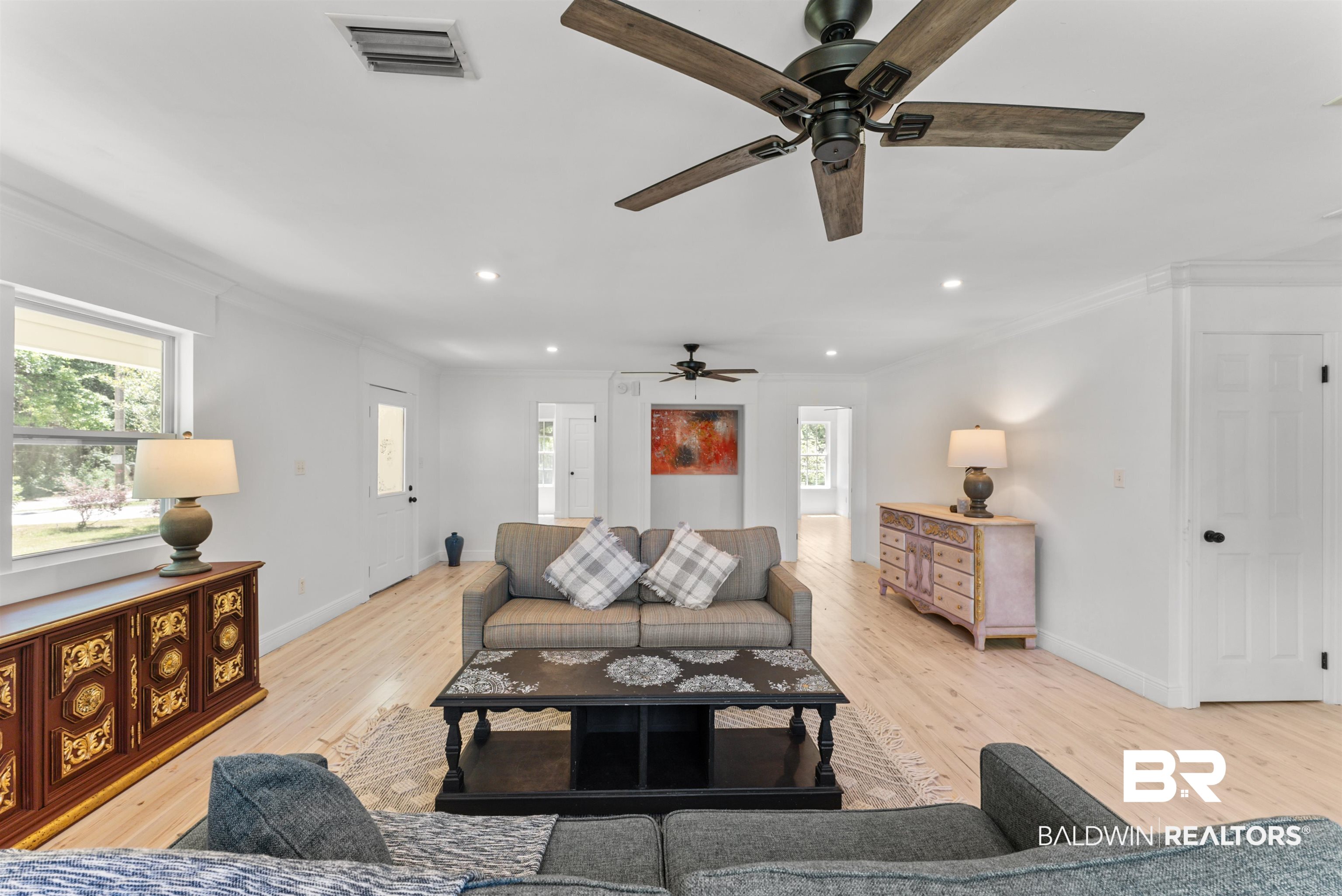 6447 Bemis Lane Bon Secour, AL 36511 - Photo 20 of 62 Spacious interior featuring light wood-finish flooring, white walls, and crown molding