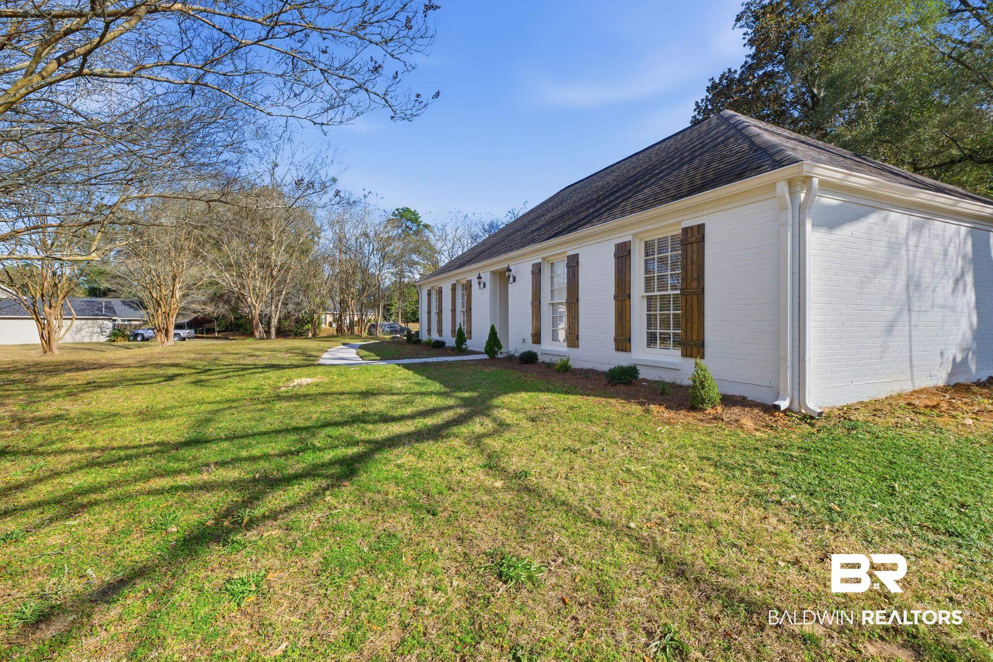 814 Nassau Drive Mobile, AL 36608 - Photo 31 of 44 View of side of property featuring a lawn and brick siding