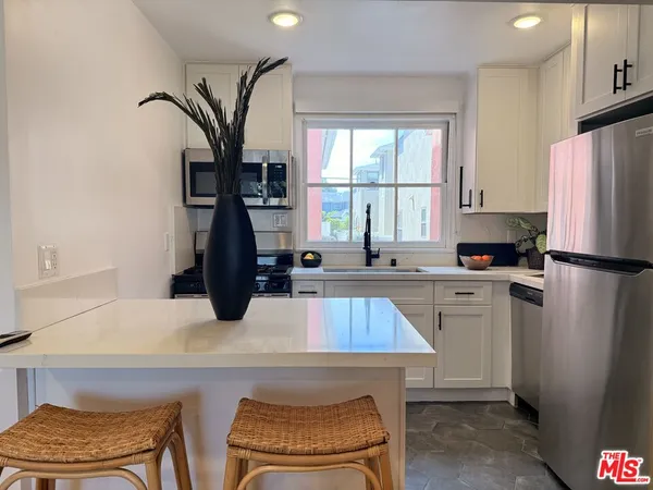 a kitchen with a refrigerator and a sink