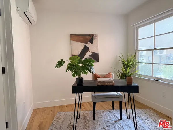 a workspace with furniture and a potted plant