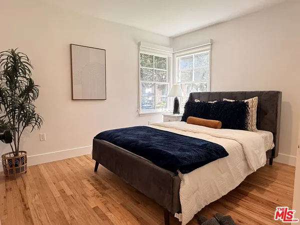 a bedroom with a bed and window