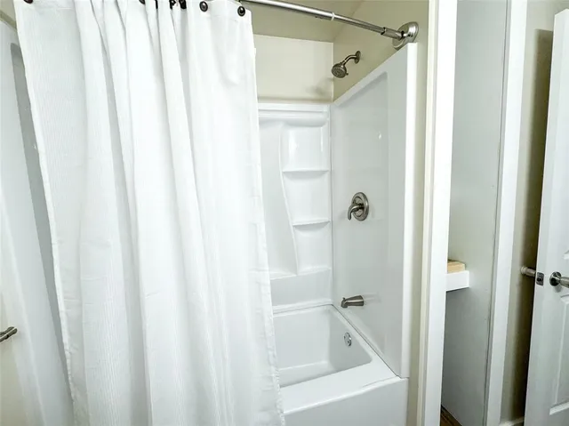 a bathroom with a glass shower door and a sink