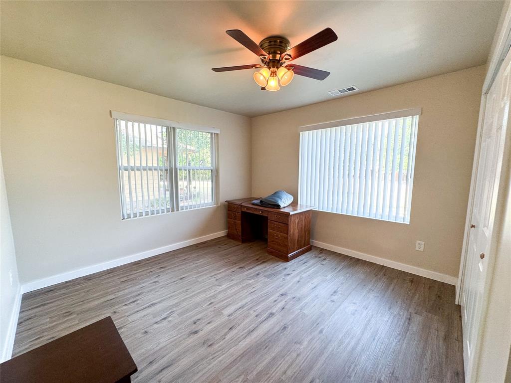 505 Main Street Rochester, TX 79544 - Photo 17 of 24 a view of an empty room with a window and wooden floor