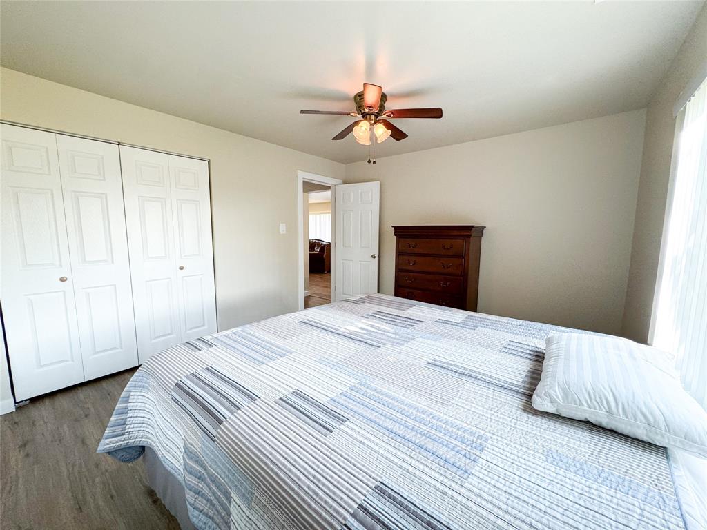 505 Main Street Rochester, TX 79544 - Photo 19 of 24 a bedroom with a bed and wooden floor