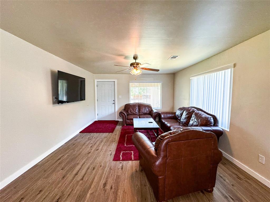 505 Main Street Rochester, TX 79544 - Photo 4 of 24 a bedroom with two beds and a flat screen tv