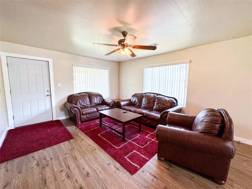 505 Main Street Rochester, TX 79544 - Photo 6 of 24 a living room with furniture a ceiling fan and a rug