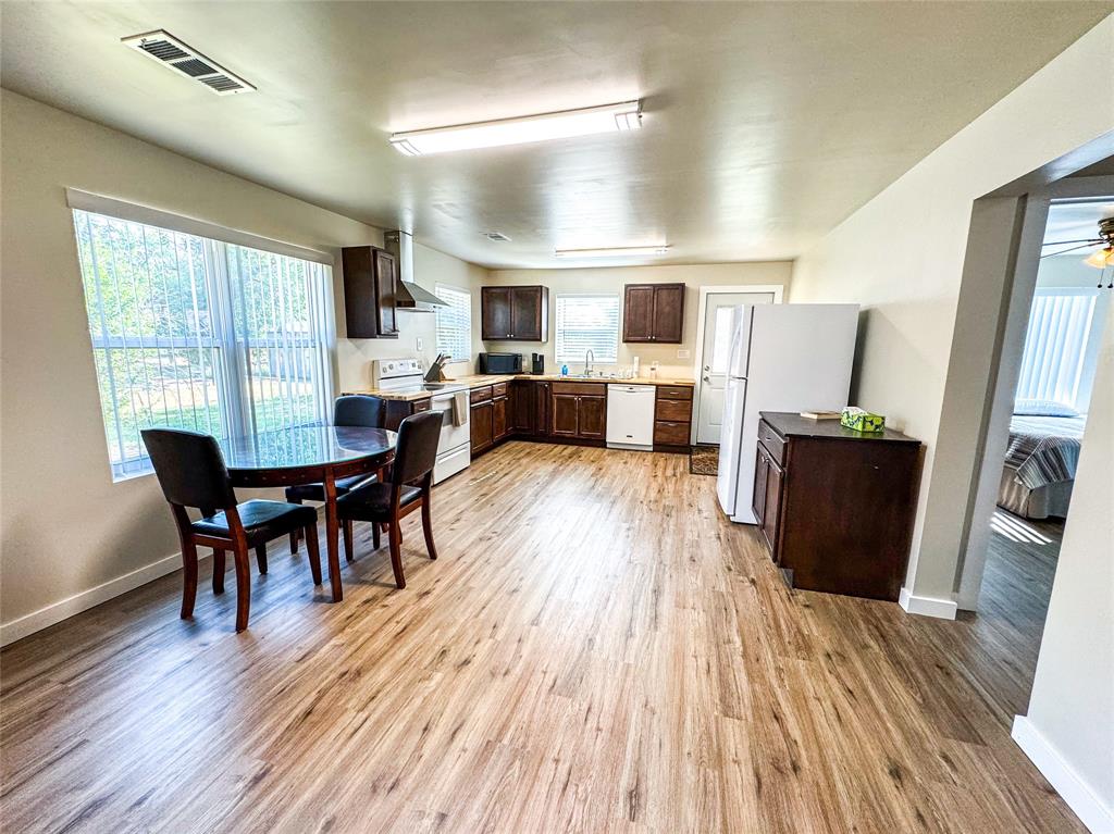 505 Main Street Rochester, TX 79544 - Photo 8 of 24 a view of a dining room with furniture and wooden floor